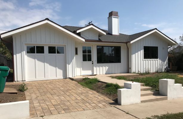 Newly built home with board and batten siding and black steel frame windows including ADU in Santa Barbara, CA