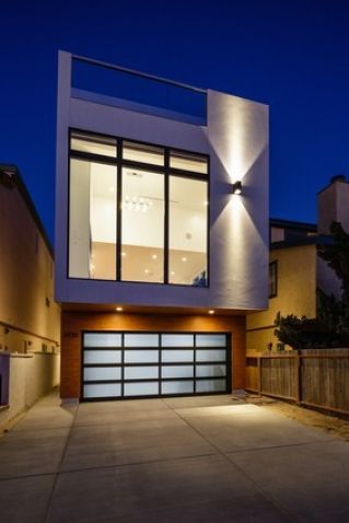 MD+B designed and built this 3-story beach home with high ceilings, large windows and roof deck over a 2-car garage