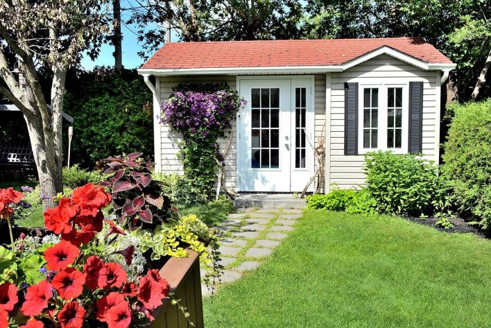Charming example of affordable detached ADU highlighting simple cottage styling with landscaped garden.
