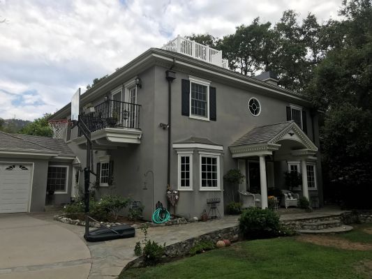Contemporary photo of Pasadena home with Widow's Walk, bedroom balcony, entry portico & 2-car garage wing